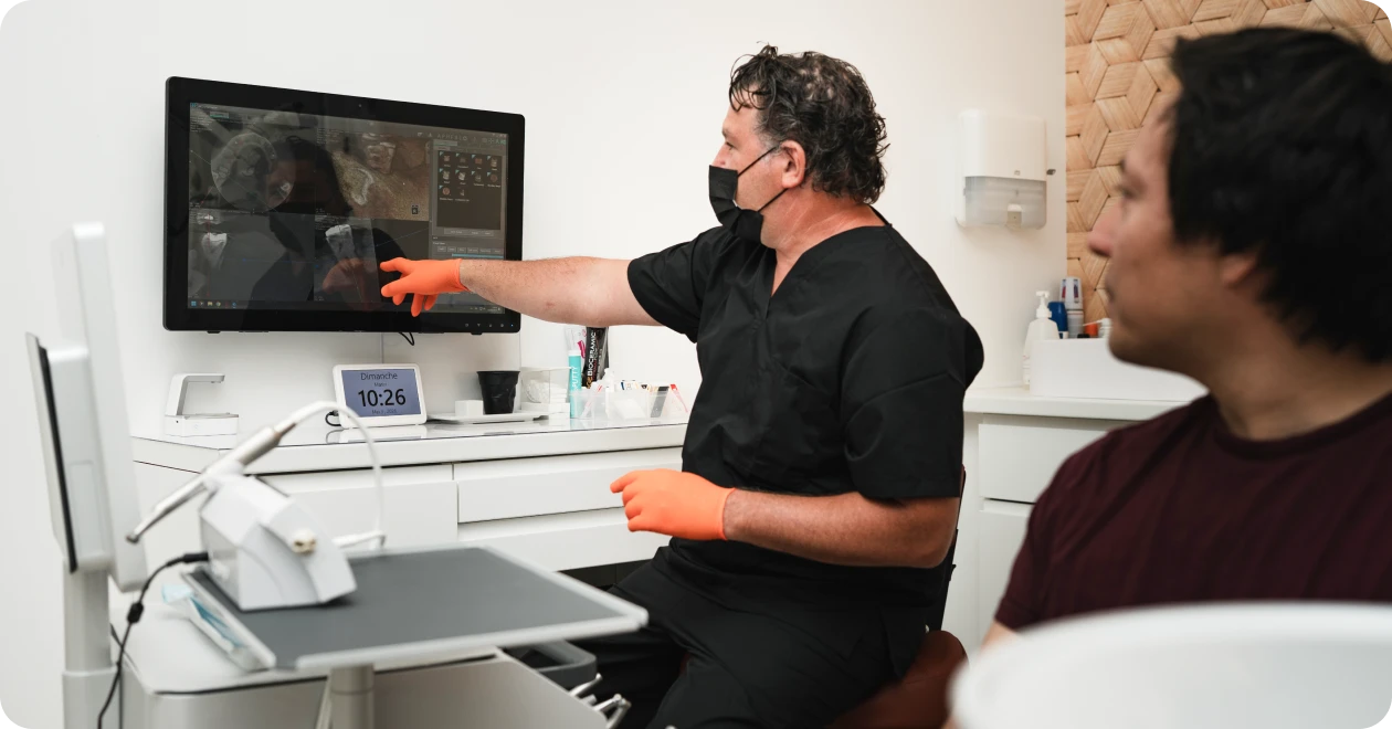 Explication d’une radiographie à un patient sur écran en salle de soins